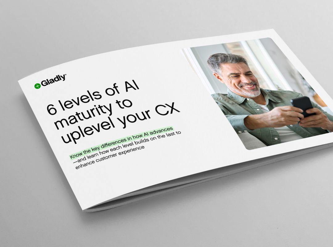 A brochure titled "6 levels of AI maturity to uplevel your CX" with a smiling person using a smartphone, conveying a positive tone about enhancing customer experience.