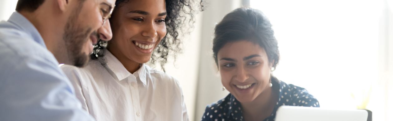 A group of CX practitioners testing AI on their laptop