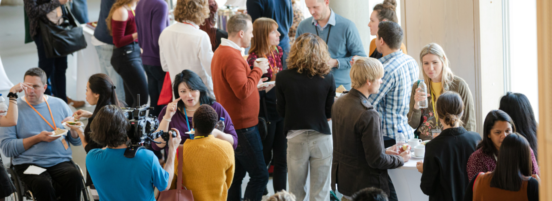 CX and retail professionals in conversation at a modern conference setting