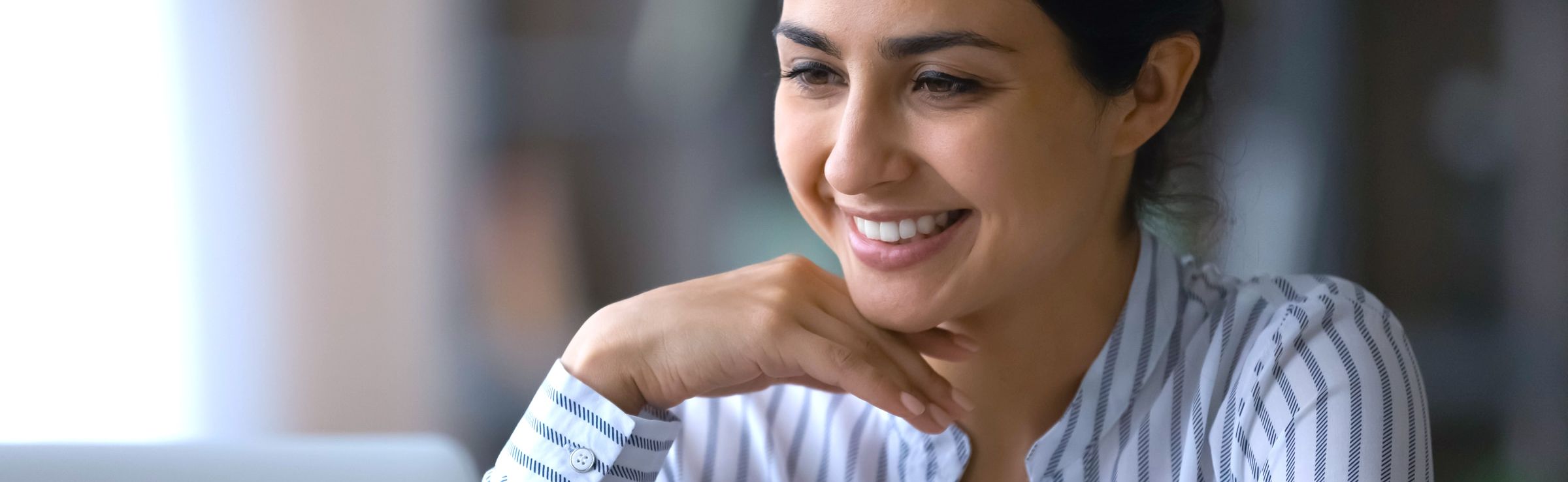 Woman smiling while looking at computer