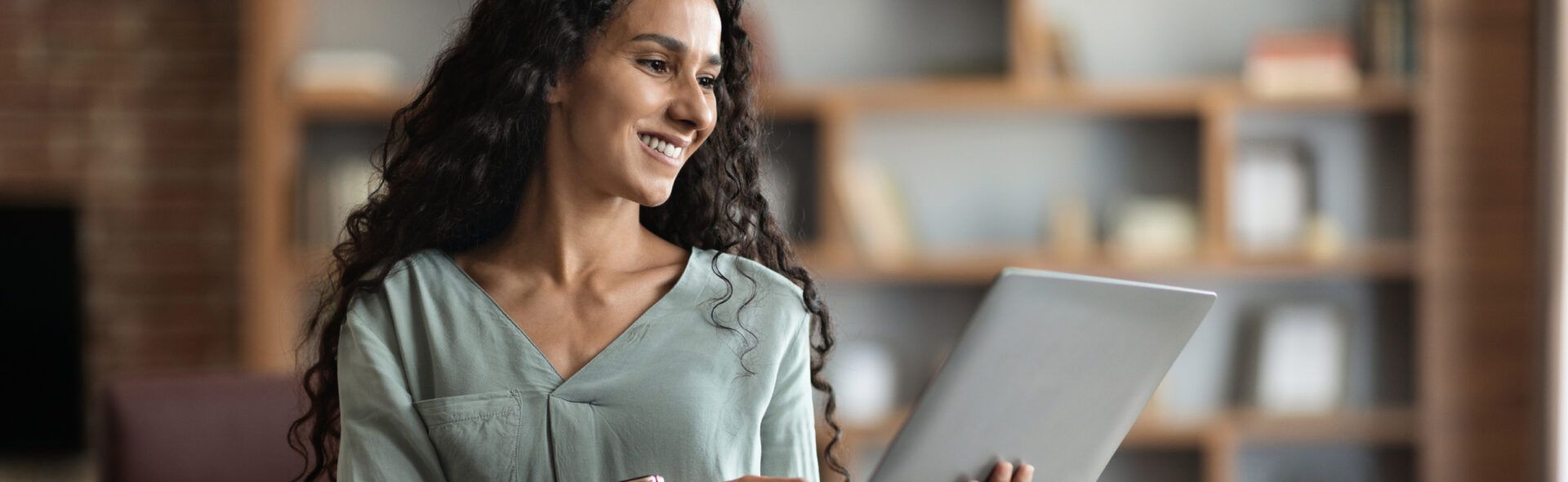 Smiling woman looking at a tablet