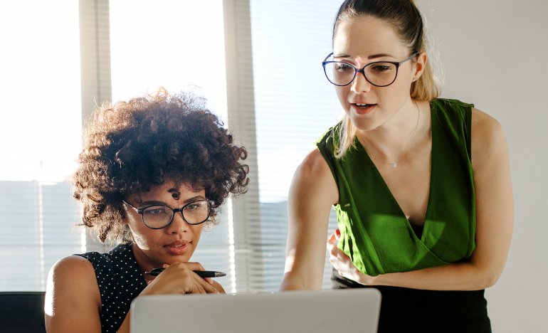 Two women looking at computer screen