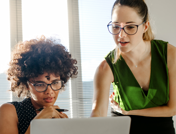 Two women looking at computer screen