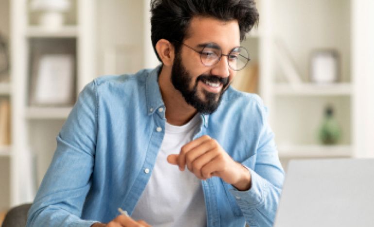 A person reading about AI misconceptions on their laptop