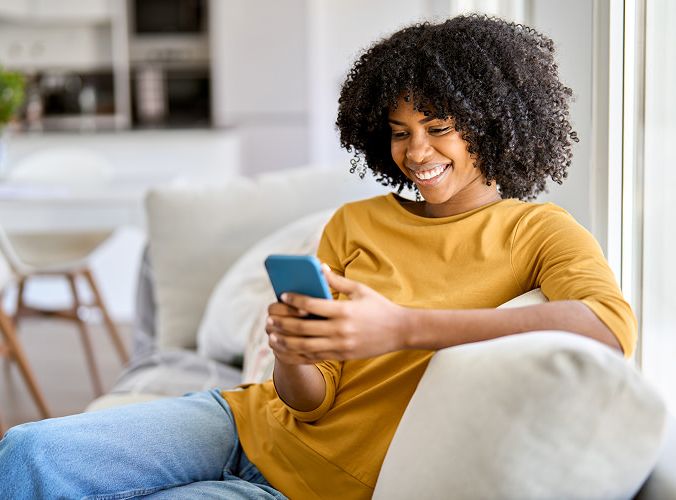 Customer looking at her phone while receiving customer support
