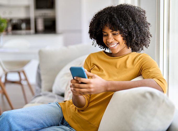 Customer looking at her phone while receiving customer support