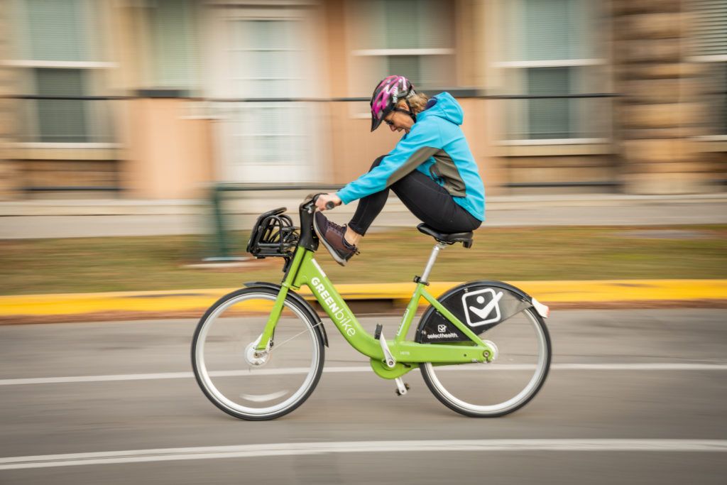 Woman riding on a Green bike
