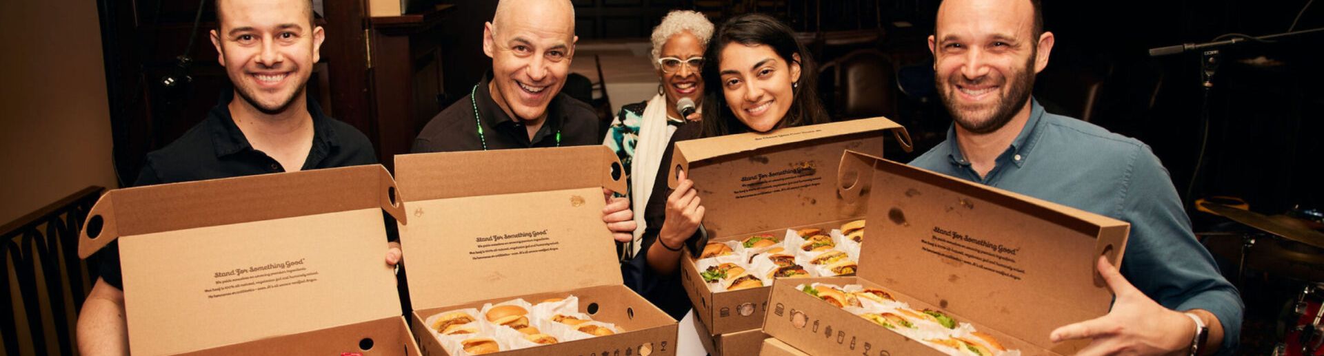 Gladly employees holding boxes of lunch smiling