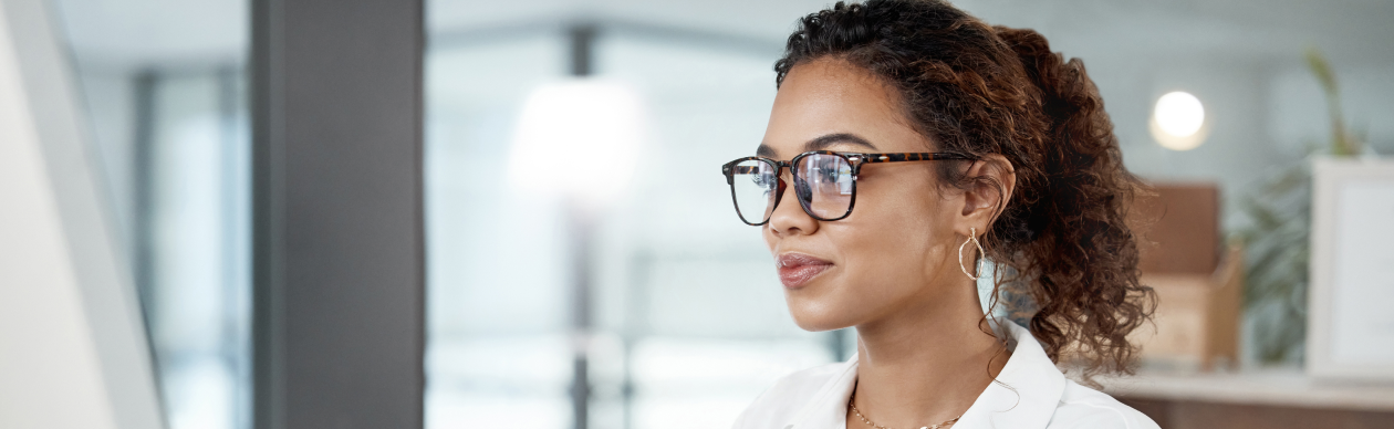 Woman with glasses using her computer