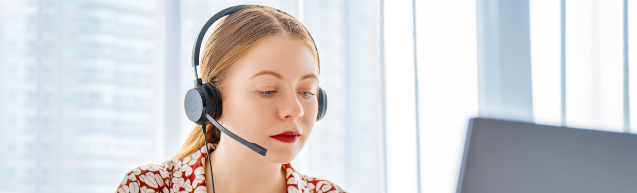 Female Customer Service Agent in front of a laptop