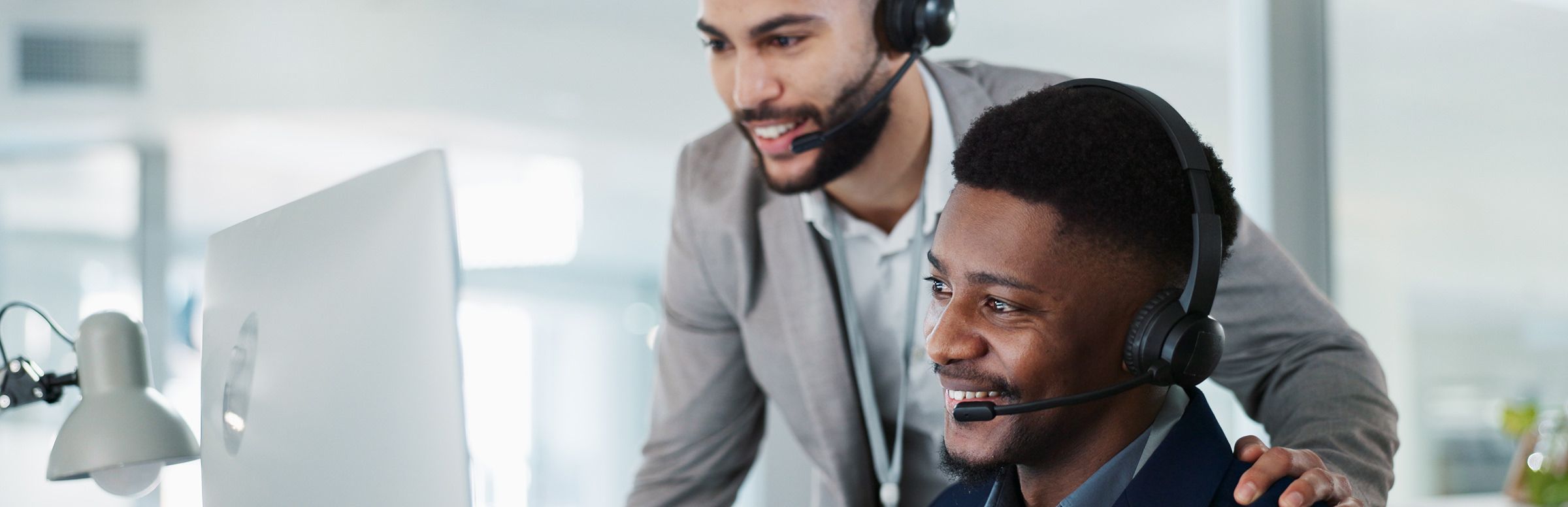 Two customer experience agents training an AI