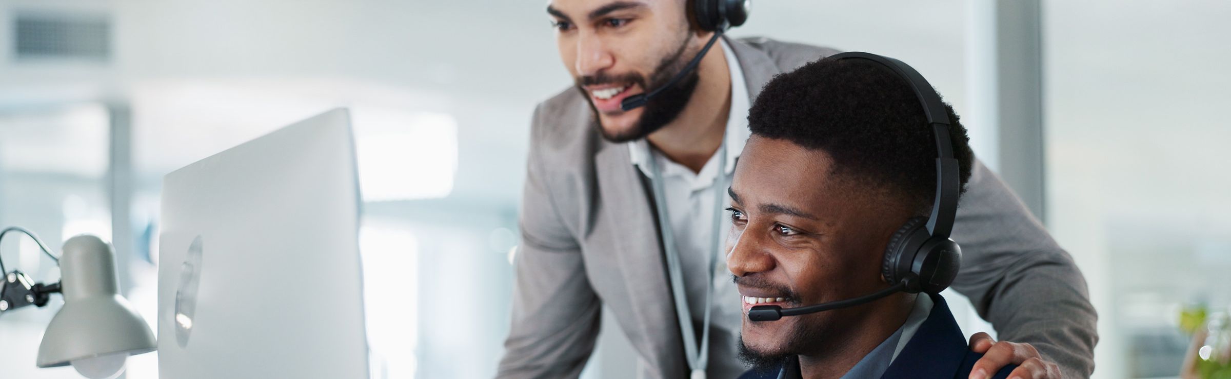 Two customer experience agents training an AI