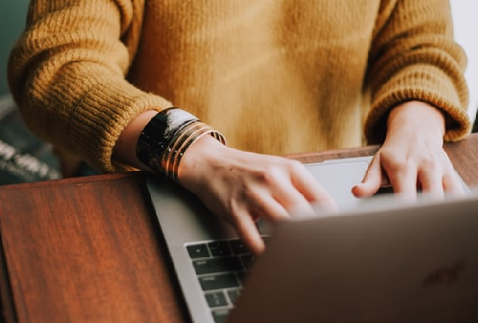 Image of a woman typing on a laptop