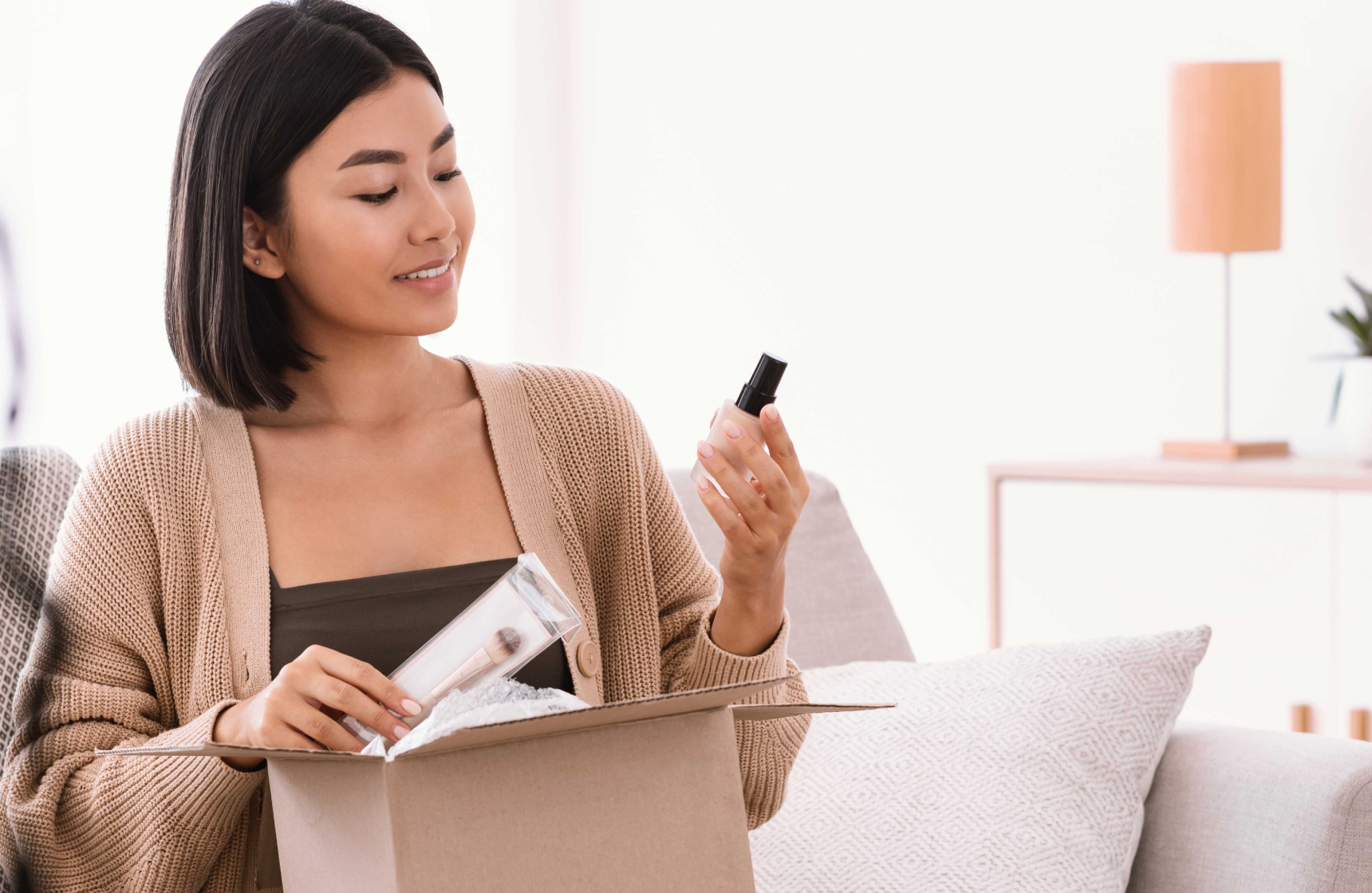 Woman opening up a box of products 