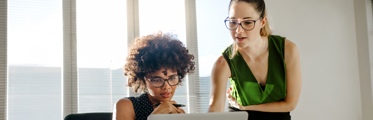 Two women looking at computer screen