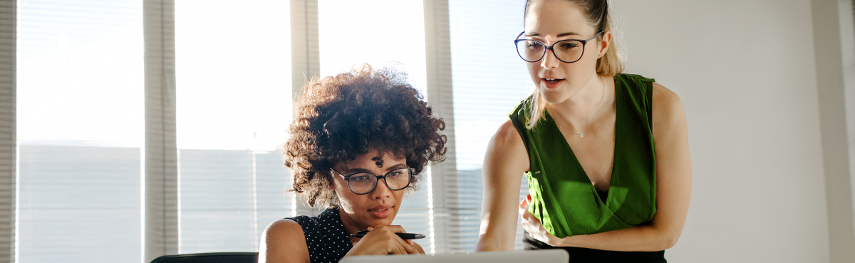 Two women looking at computer screen