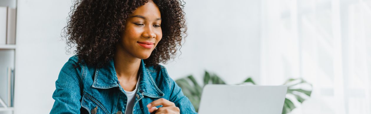 A lady on the computer implementing Revenue generating cx strategies