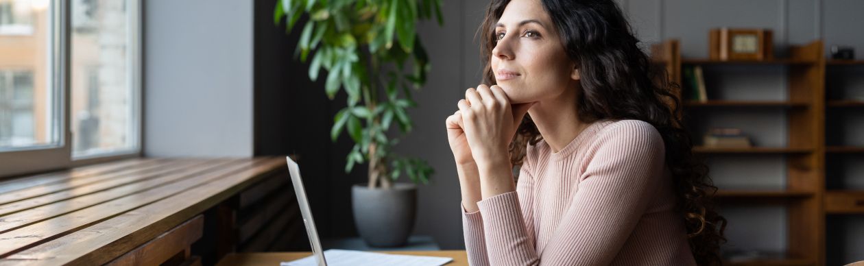 Woman thinking about how AI helps with social media moderation