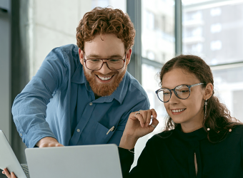 Two people collaborating with their laptops