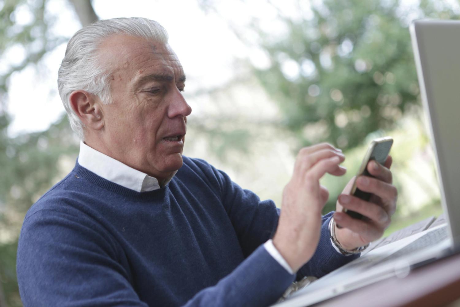 old guy searching on tablet