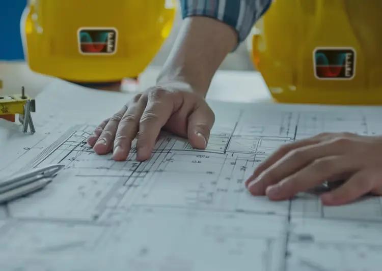 Blueprints and construction hats