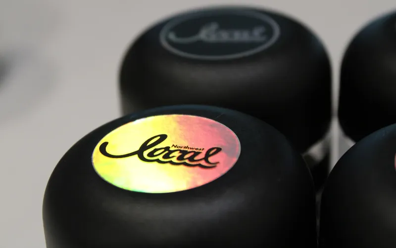 Holographic Northwest Local logo on black jar lids.
