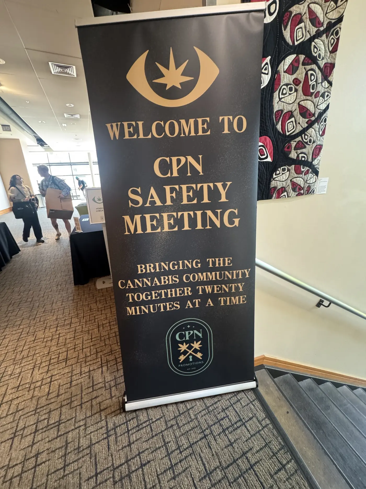 A tall welcome banner reading Welcome to CPN Safety Meeting, bringing the cannabis community together twenty minutes at a time, at the top of a staircase.