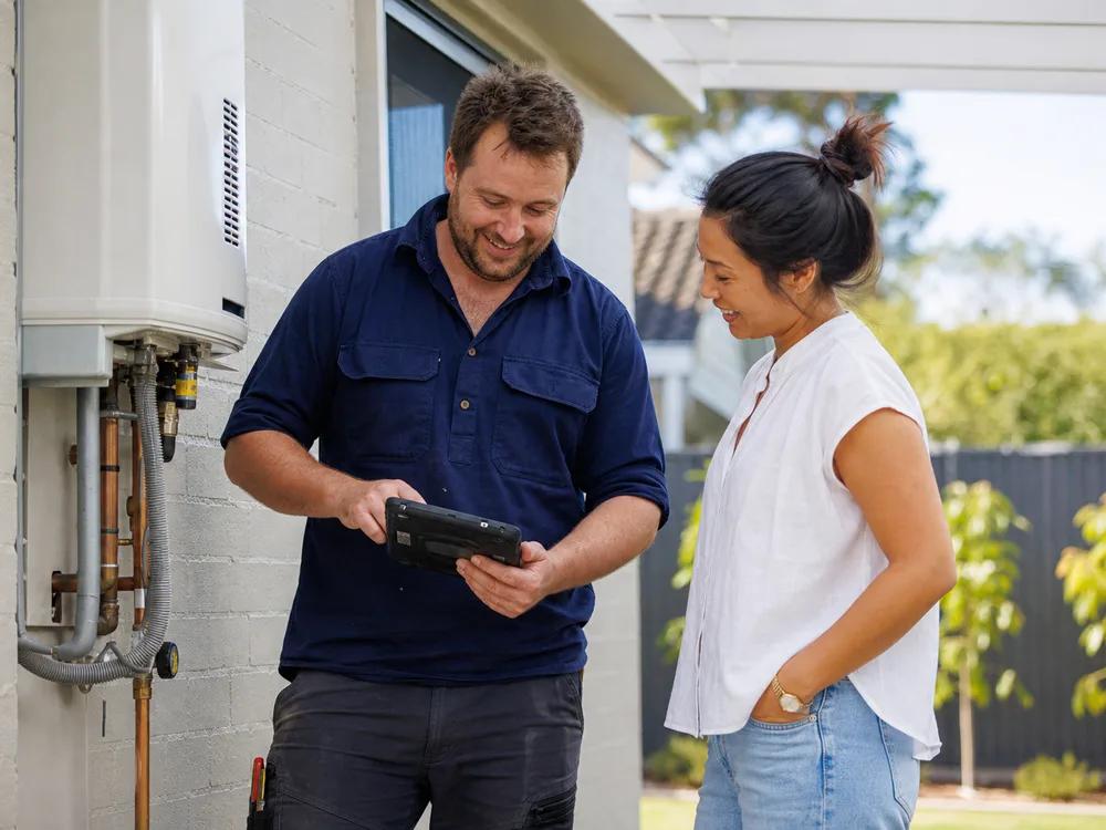 Australian tradesperson discussing completed work with a homeowner