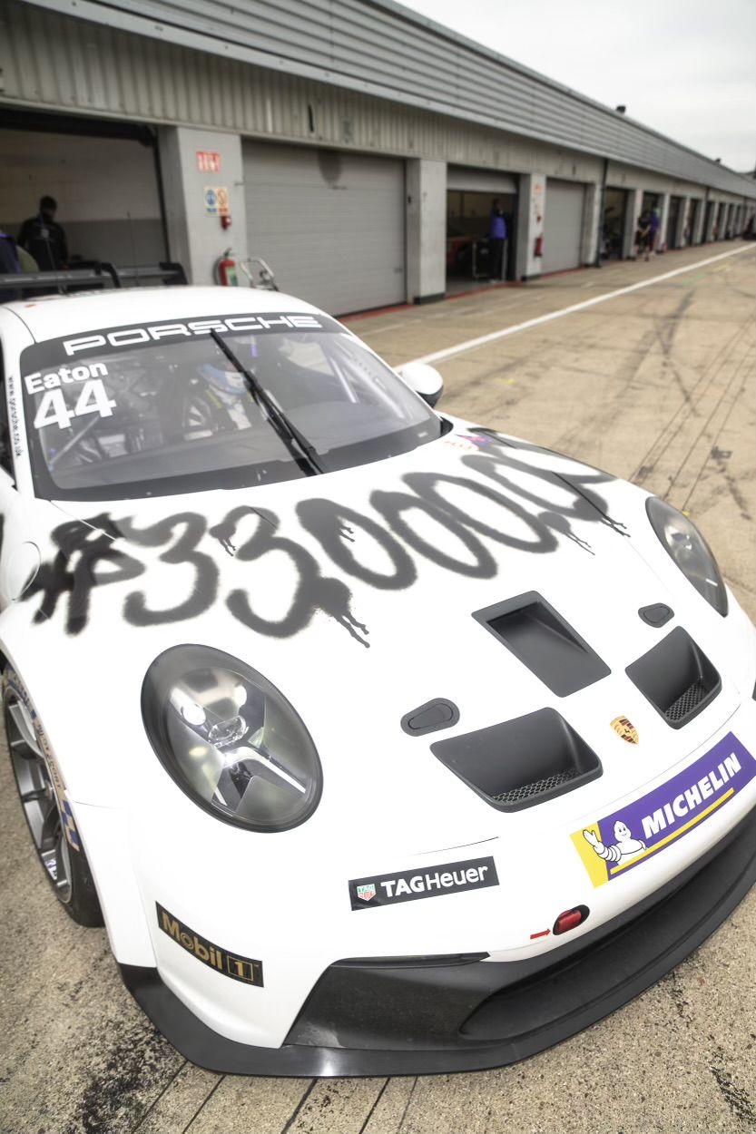 The white livery of Abbie's GT3 has street-style tagging across the hood in black spraypraint that reads "$33,000,000" to highlight the cost of motorsport