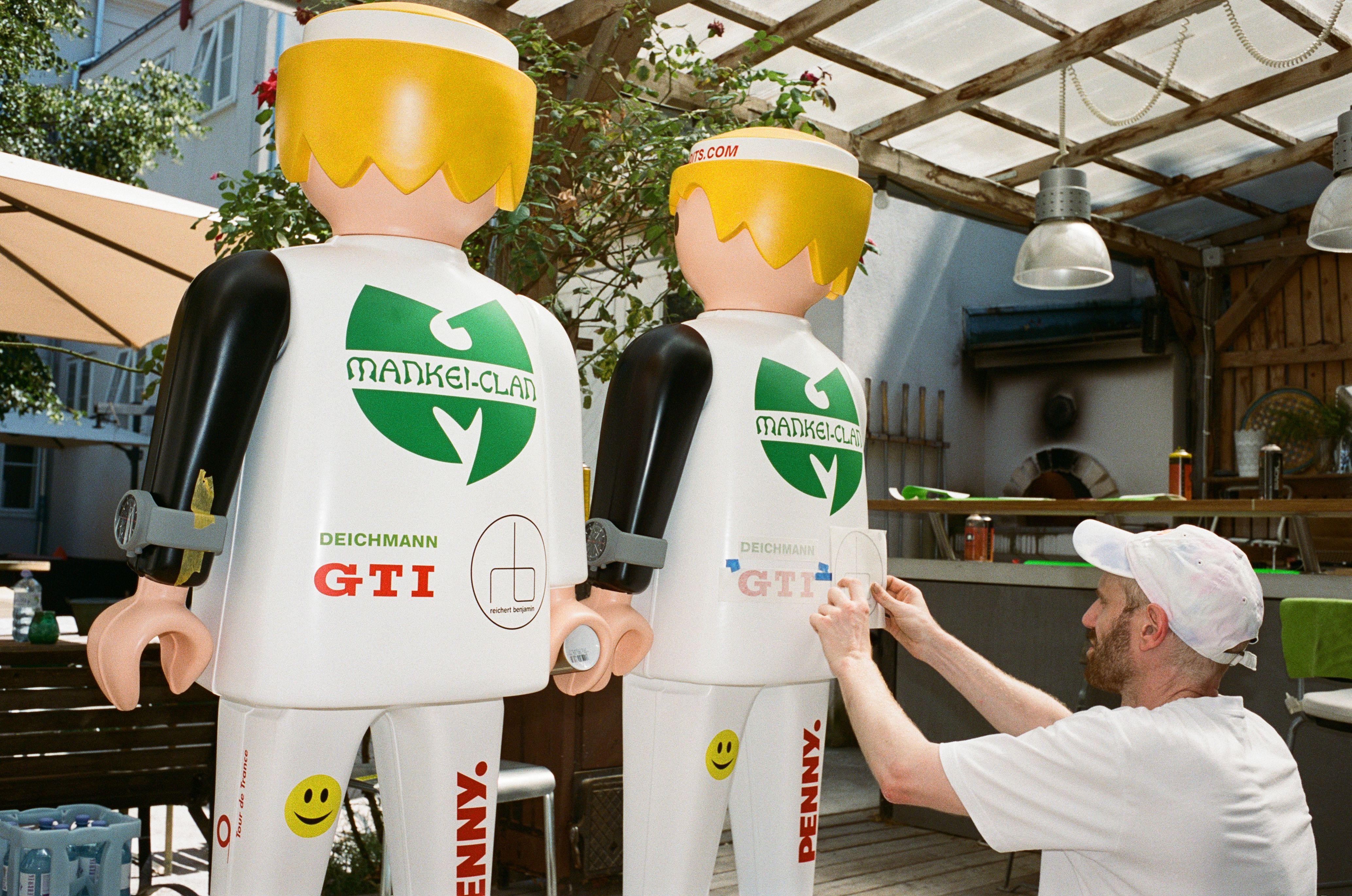 Artist Martin Grandits placing final graphics on the Playmobil FAT International racing driver figures he created