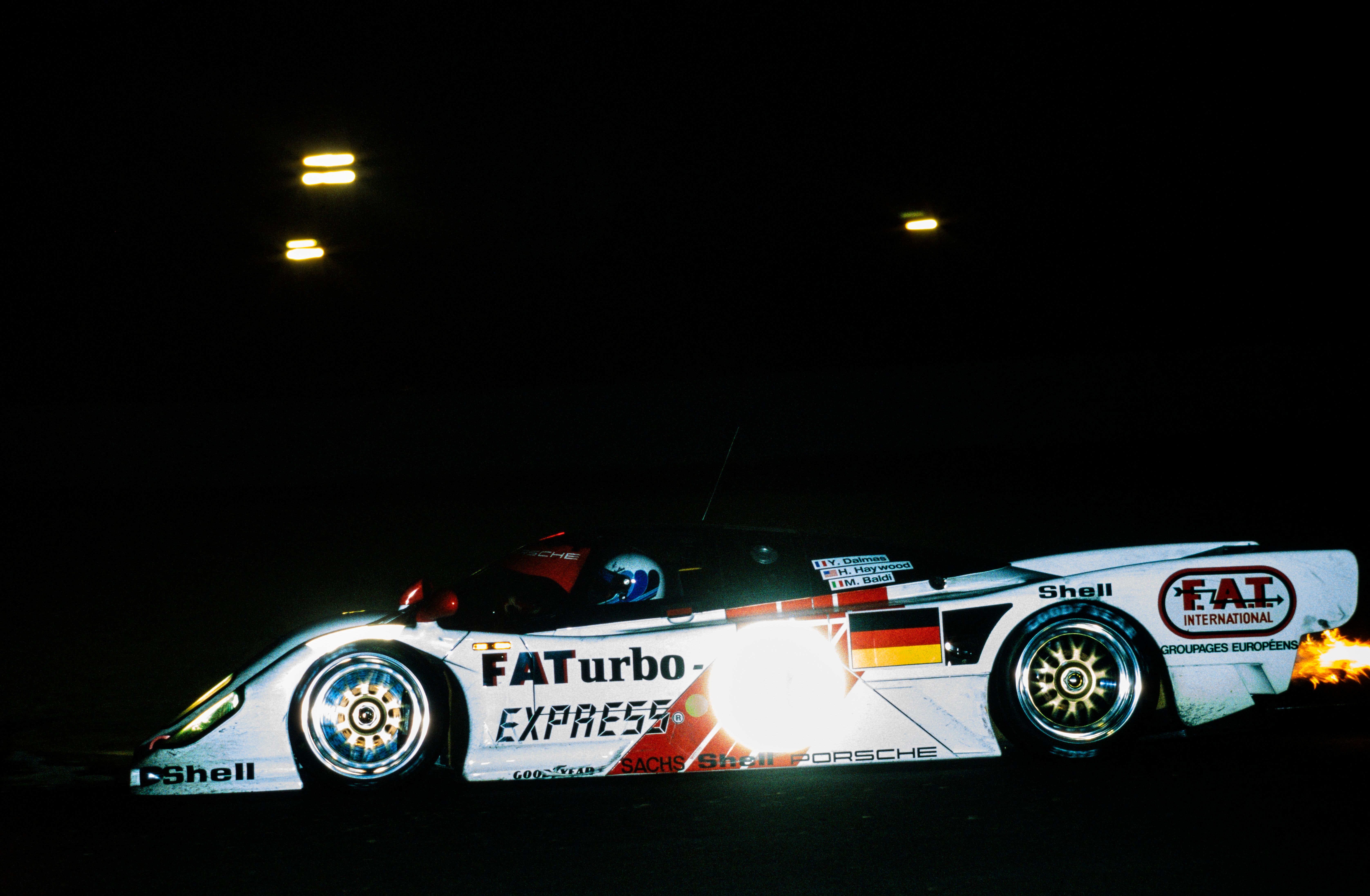 Racing the 1994 Le Mans at night, a flash picture of the Dauer Porsche 962 LM Sport GT with FATurbo Express logos and exhaust backfiring with flames