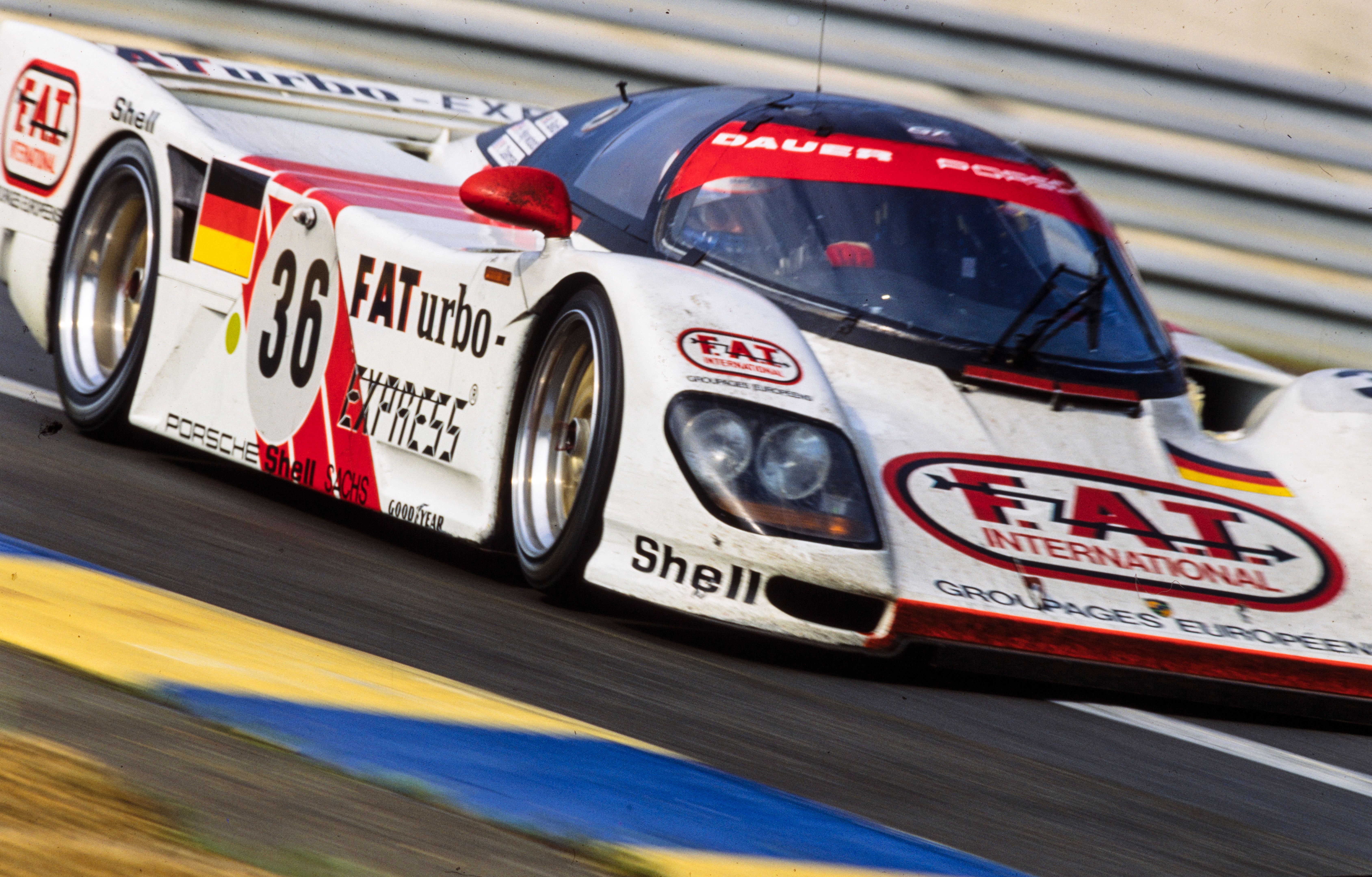 The Dauer Porsche 962 LM Sport GT racing at Le Mans 1994, wearing a white livery with red accents and FAT International logos