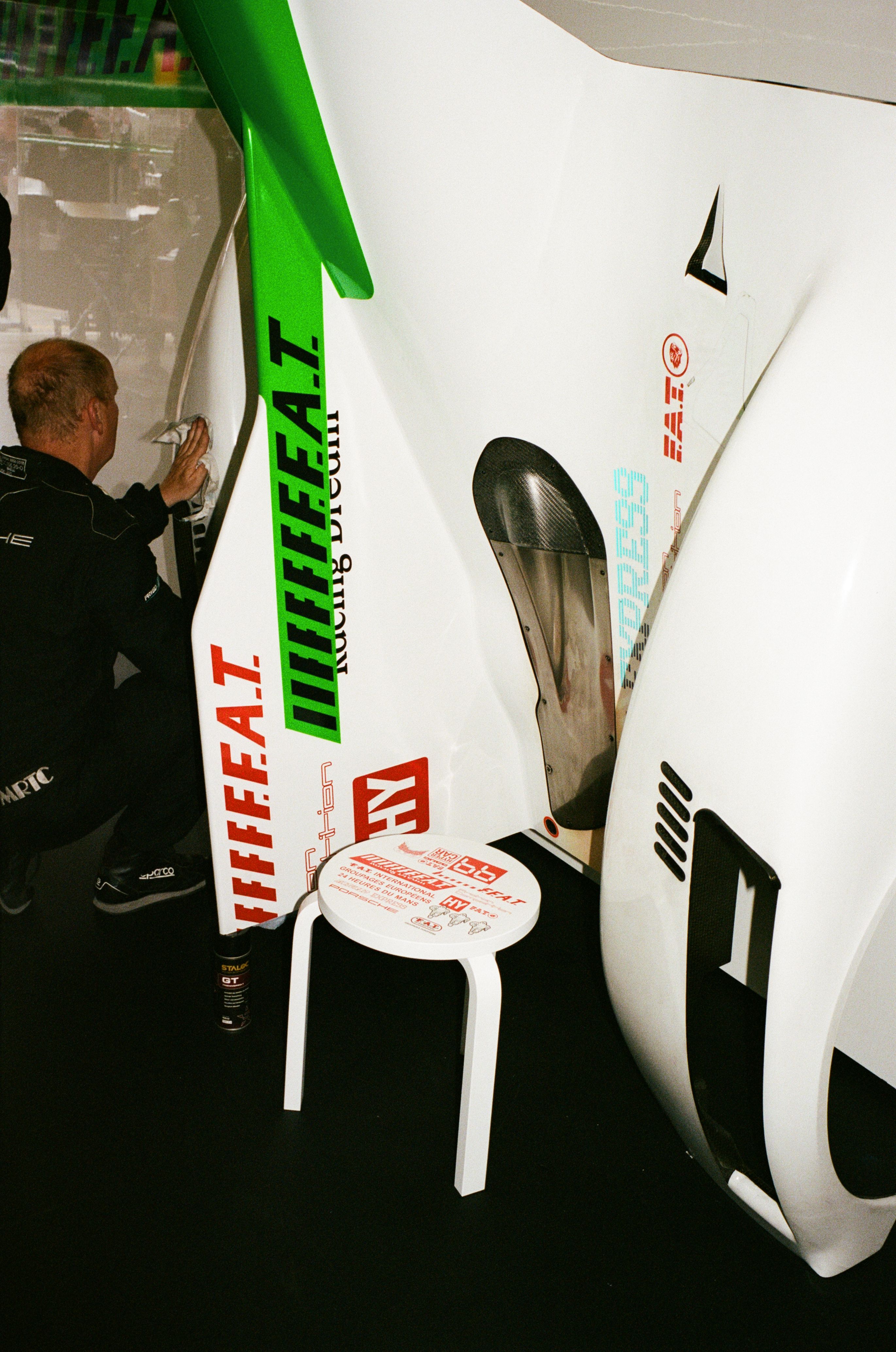 Proton Competition team member preparing the body and back wing of the 963 for the 24 hour race