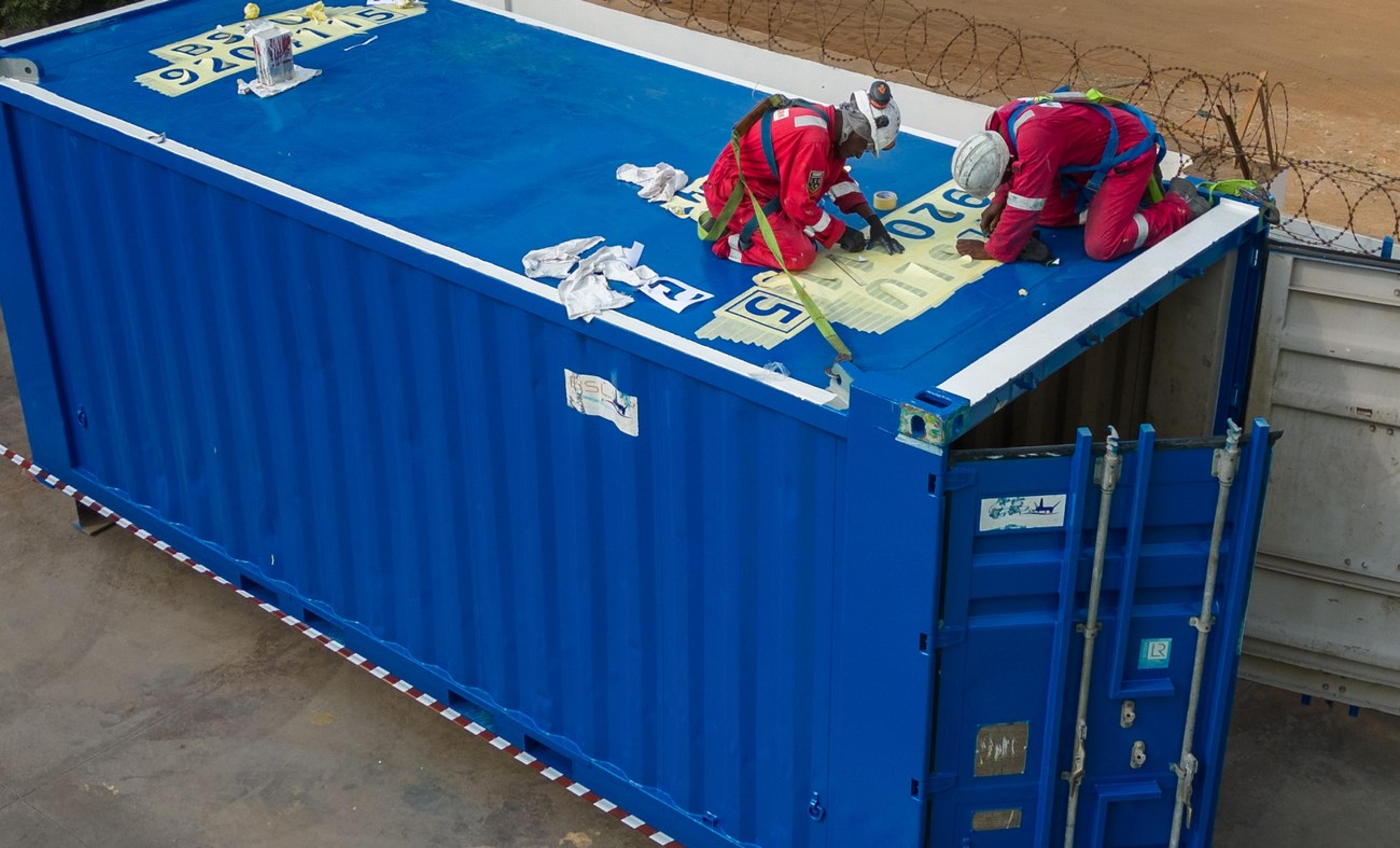 Technicians marking up a container as part of the training programme