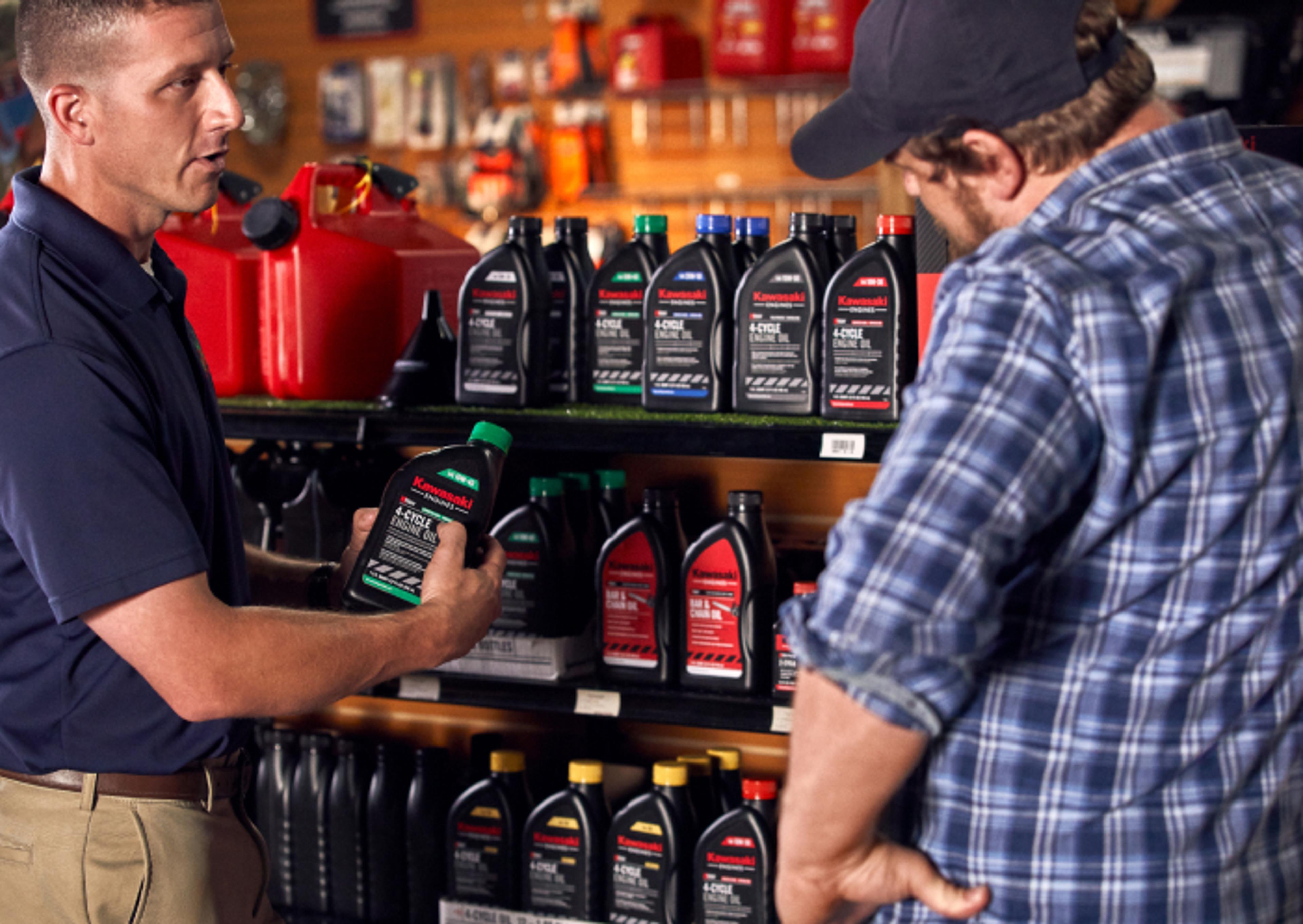 Salesperson and customer discussing Kawasaki engine oil.