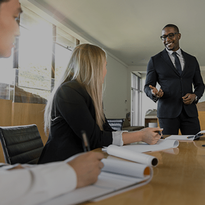 How to inspire people to work with you image of man standing addressing office workers