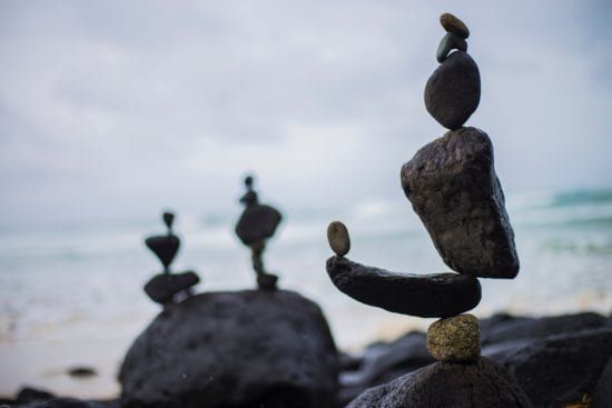 a group of rocks stacked on top of each other on a beach .