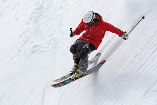 a person is skiing down a snow covered slope .