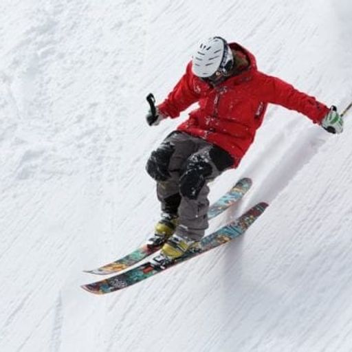 a person is skiing down a snow covered slope .