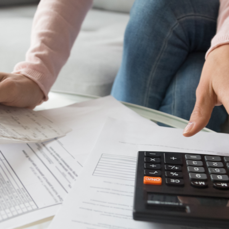 How your business can benefit from the U.S. government’s stimulus package image a woman is using a calculator to calculate her bills