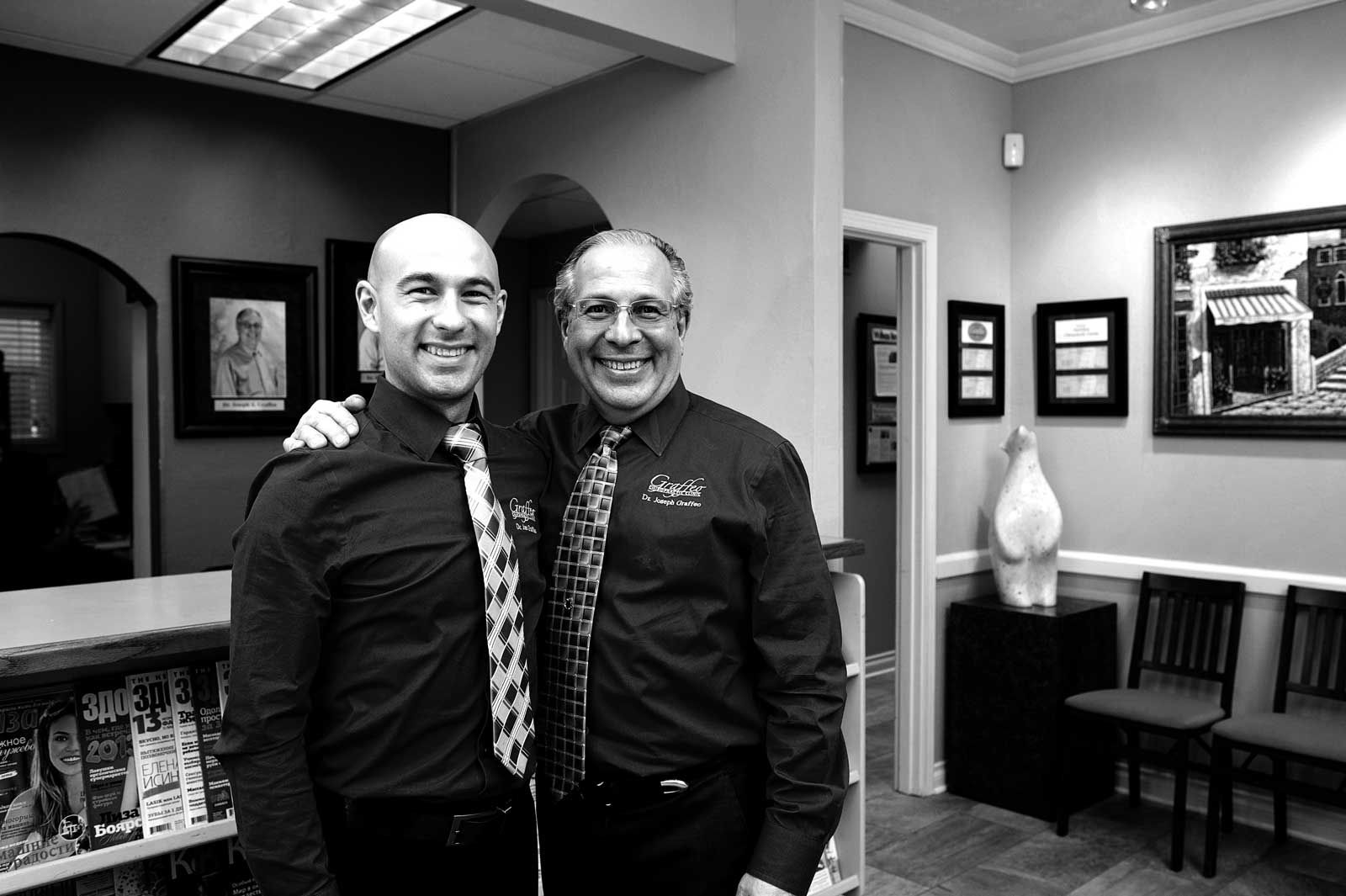 two men are standing next to each other in a waiting room .