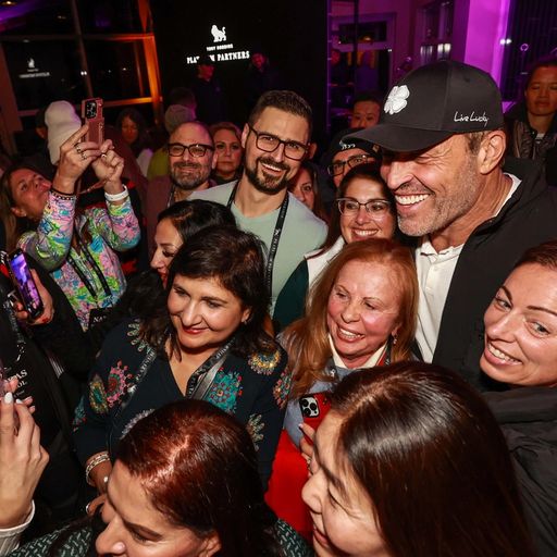 a group of people are posing for a picture with a man in a hat .