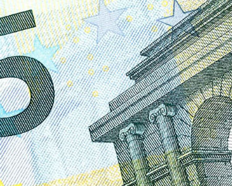 a close up of a 5 euro bill with a building in the background .