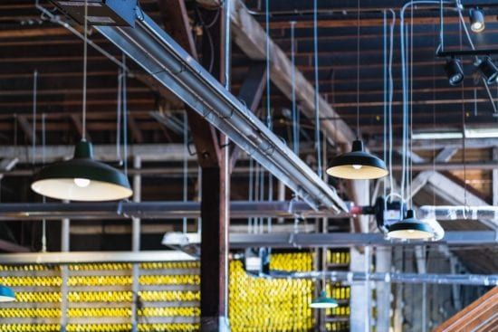 a bunch of lights are hanging from the ceiling of a building .