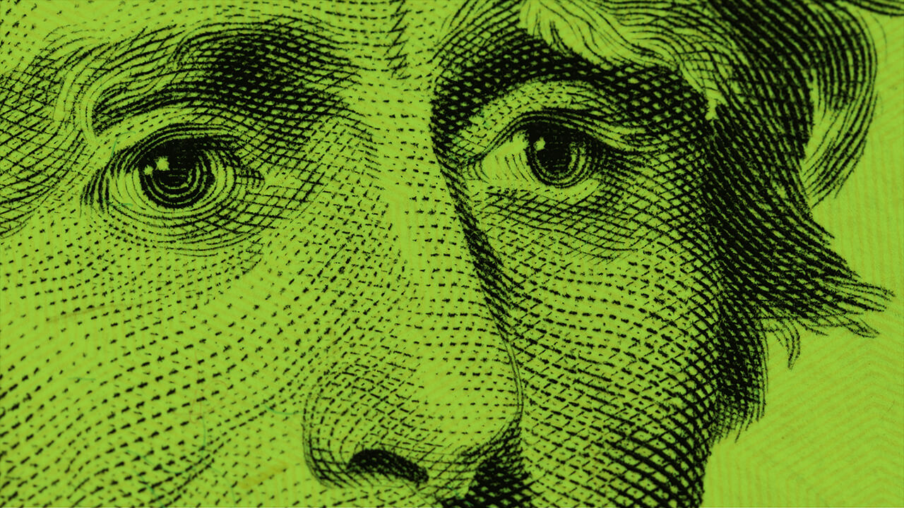 a close up of a dollar bill with a green background