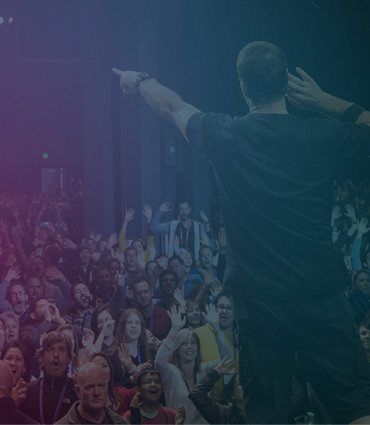Embracing your relationship polarity image of Tony Robbins on stage overlooking audience