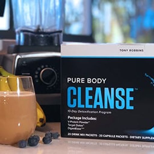 a box of pure body cleanse is sitting on a counter next to a glass of milk and fruit .