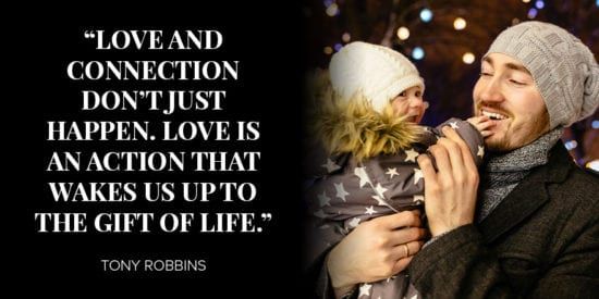 Young dad holding baby with joy