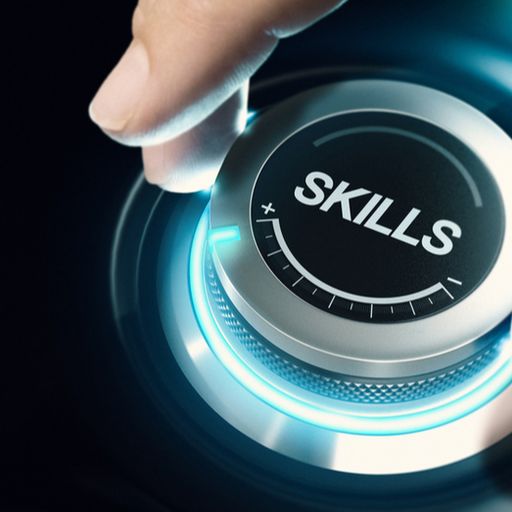 a person is pressing a button with the word skills on it .