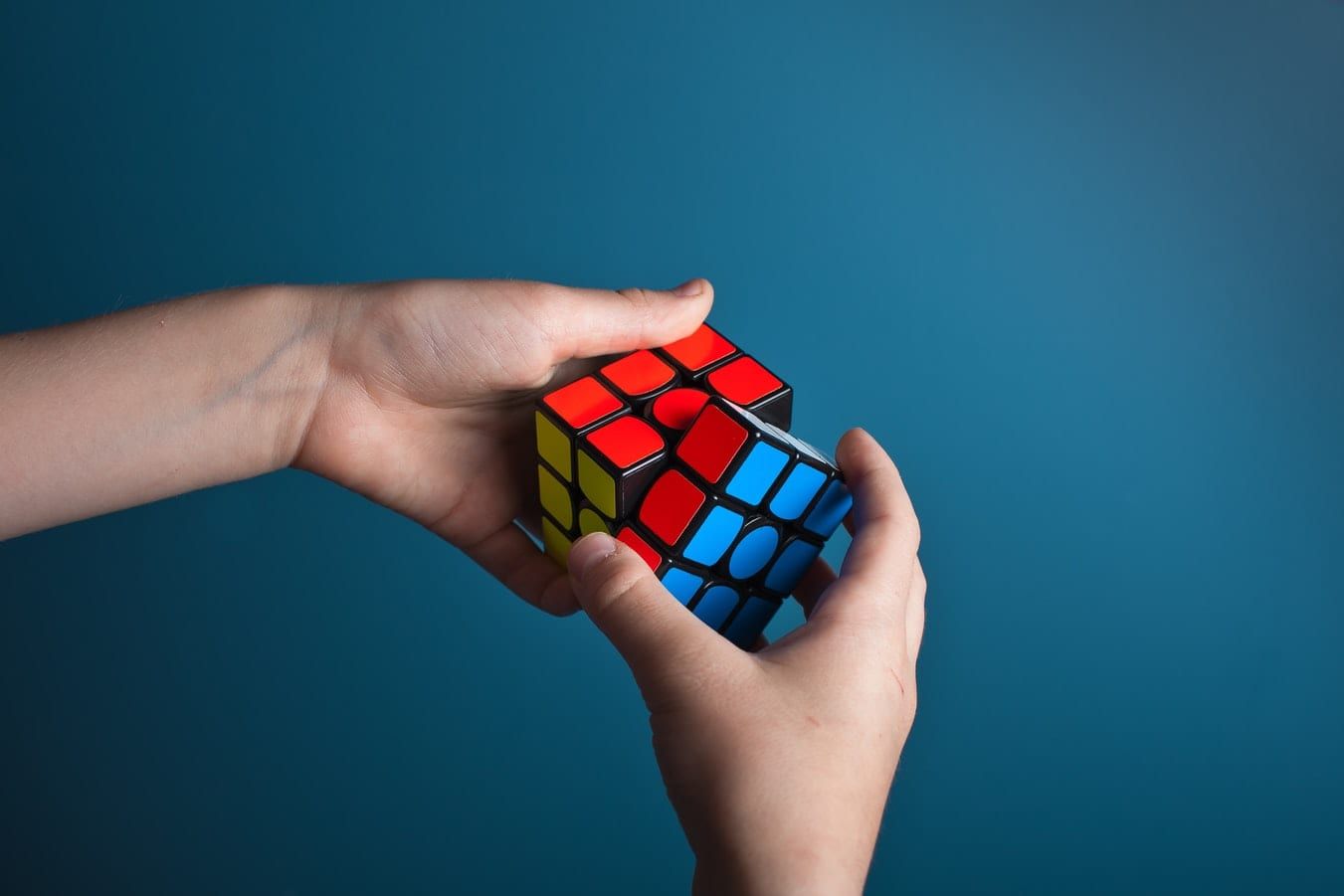 a person is holding a colorful rubik 's cube in their hands .